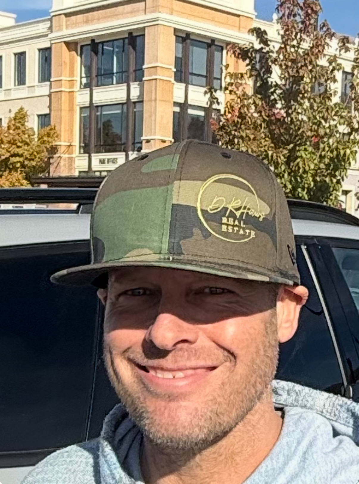 Happy client wearing DRHaws Real Estate hat