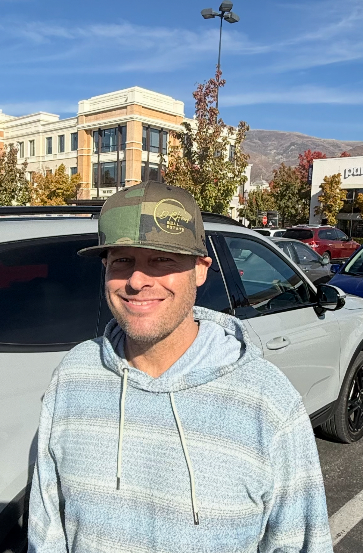 Happy client wearing DRHaws Real Estate hat