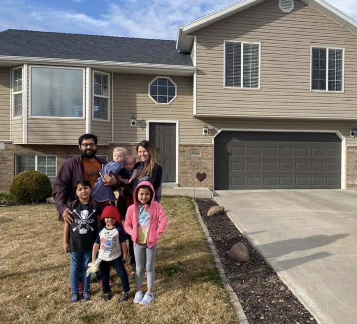 Happy first-time homebuyer family with Dr. Haws